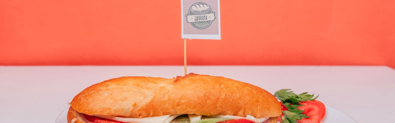 A long toasted sub packed with grilled chicken, lettuce and tomato